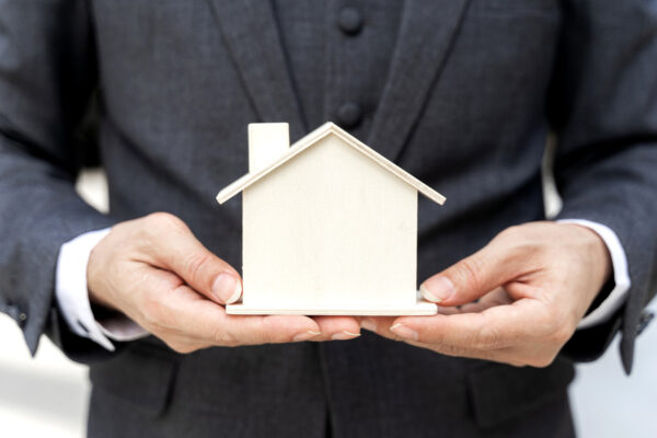 L'immagine rappresenta una piccola casa nelle mani di un uomo per simboleggiare il concetto di assicurazione casa